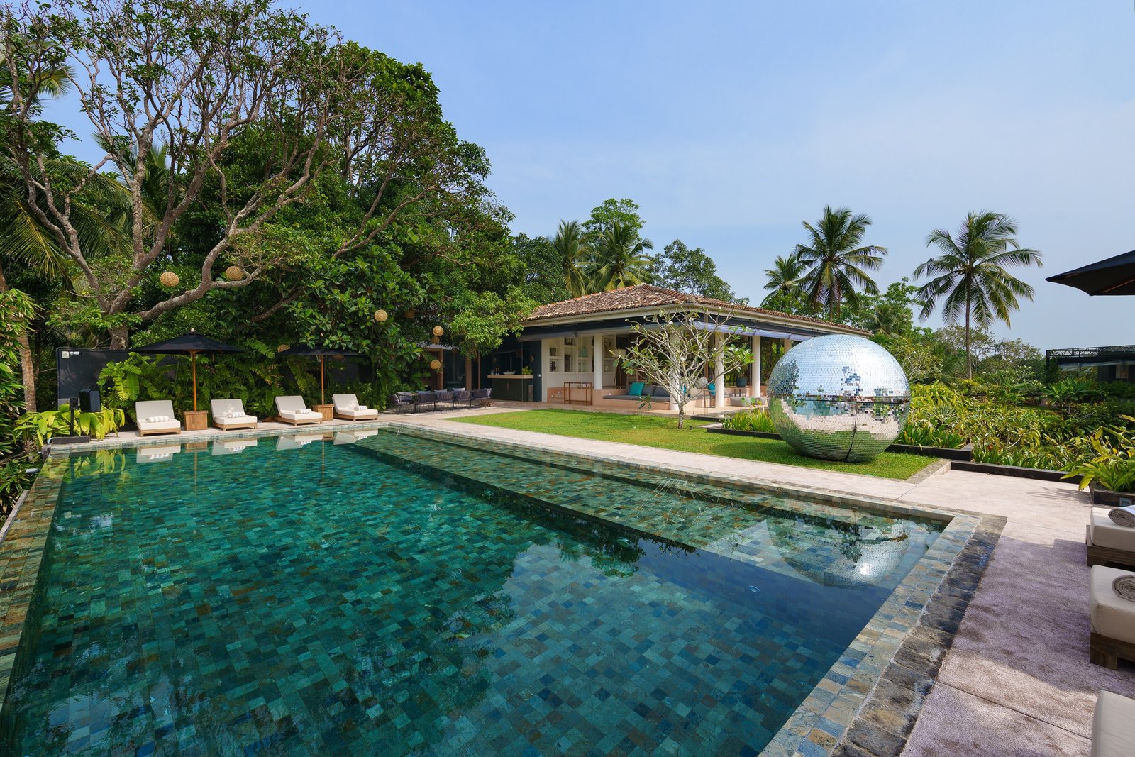Villa pool surrounded by tropical greenery